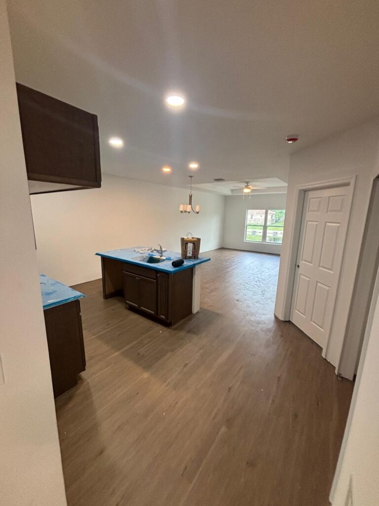 Contractor installing interlocking vinyl planks with precision in Melbourne FL home