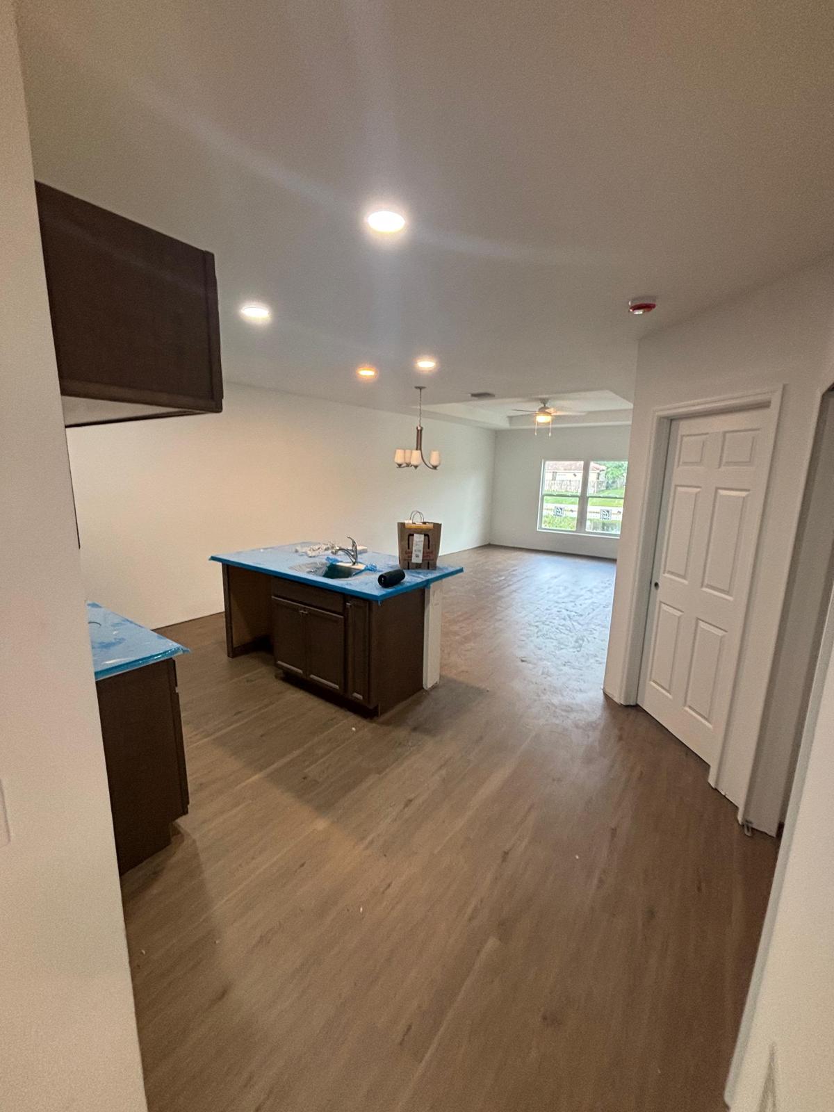 Contractor installing interlocking vinyl planks with precision in Melbourne FL home