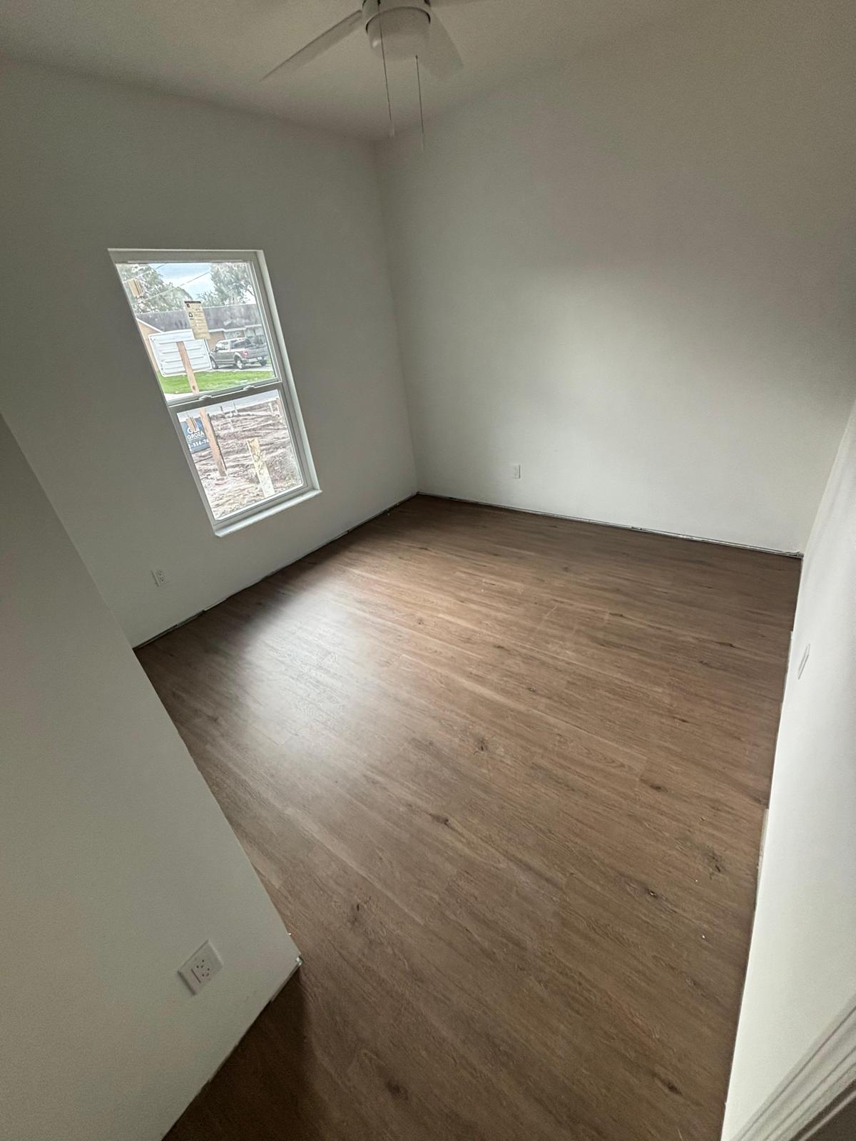 Seamless vinyl flooring installation across hallway and living room in Brevard County”
